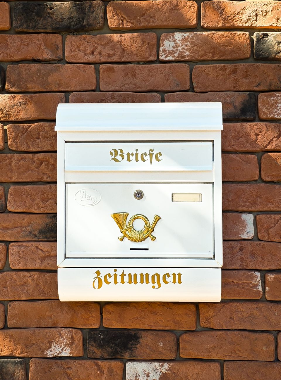 vintage german mailbox on brick wall