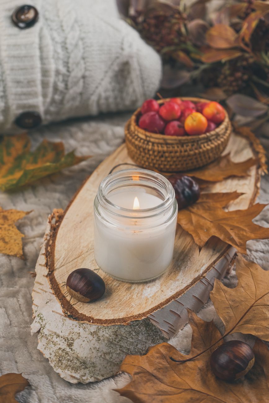 photo of a lit candle near chestnuts